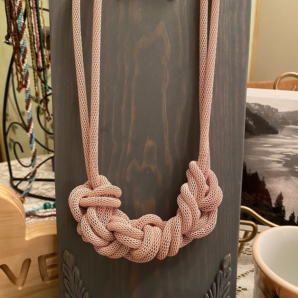 Urban Outfitters pale pink mesh chain knitted necklace. Clip earrings are sold.